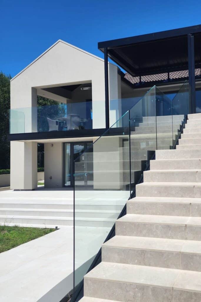 This image has a stair glass railing