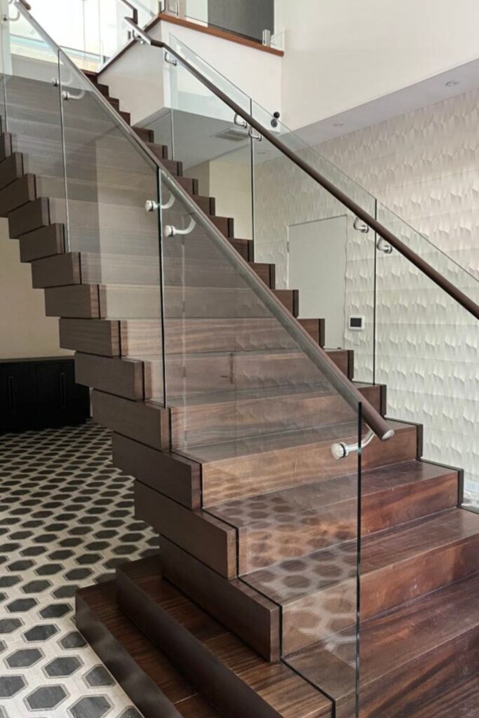 This image has a glass staircase railing