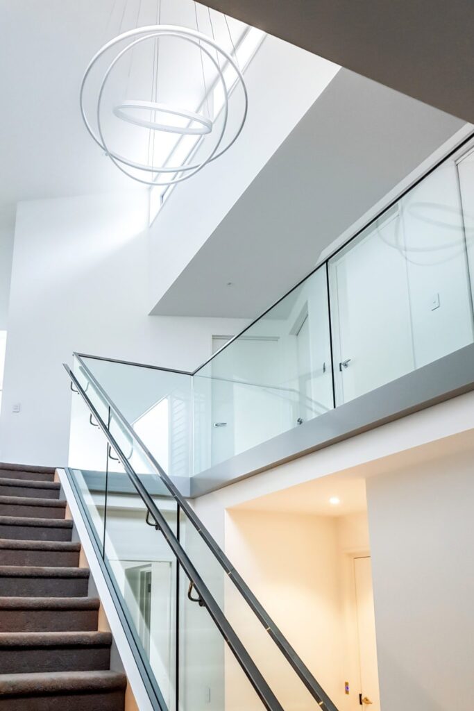 This image has a glass stair railing