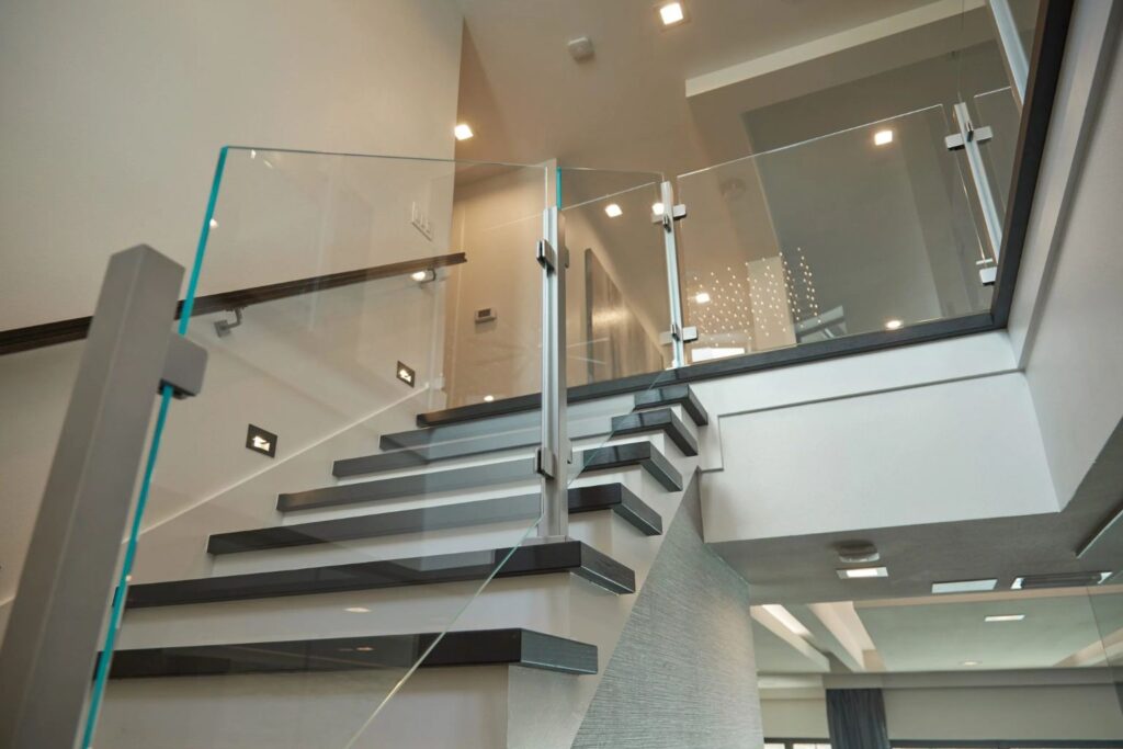 This image has a glass stair railing